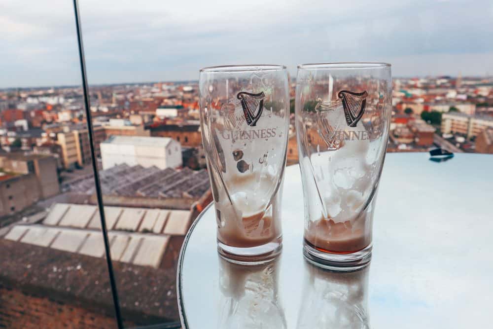 Two empty glasses of Guinness on a table.
