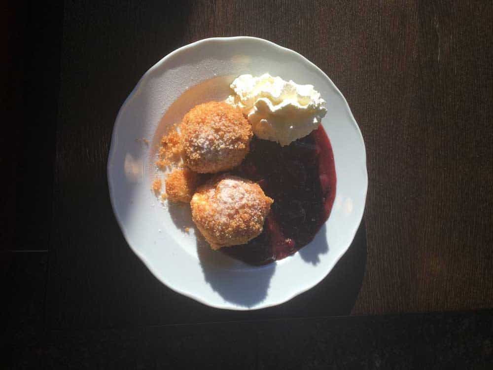 Sweets with whip cream on a white plate.