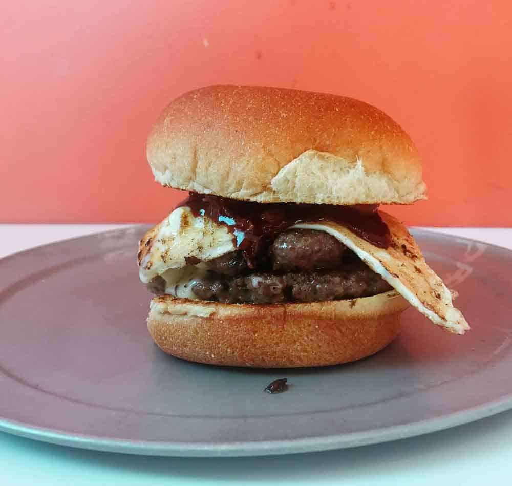 burger with egg on a plate