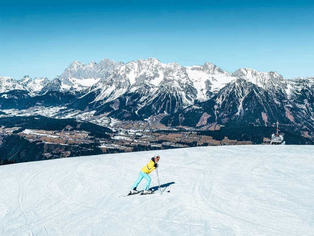 girl on skis smiling on the mountain