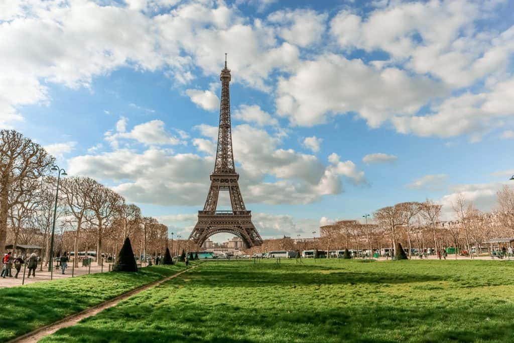 view of eiffel tower from across a grassy field