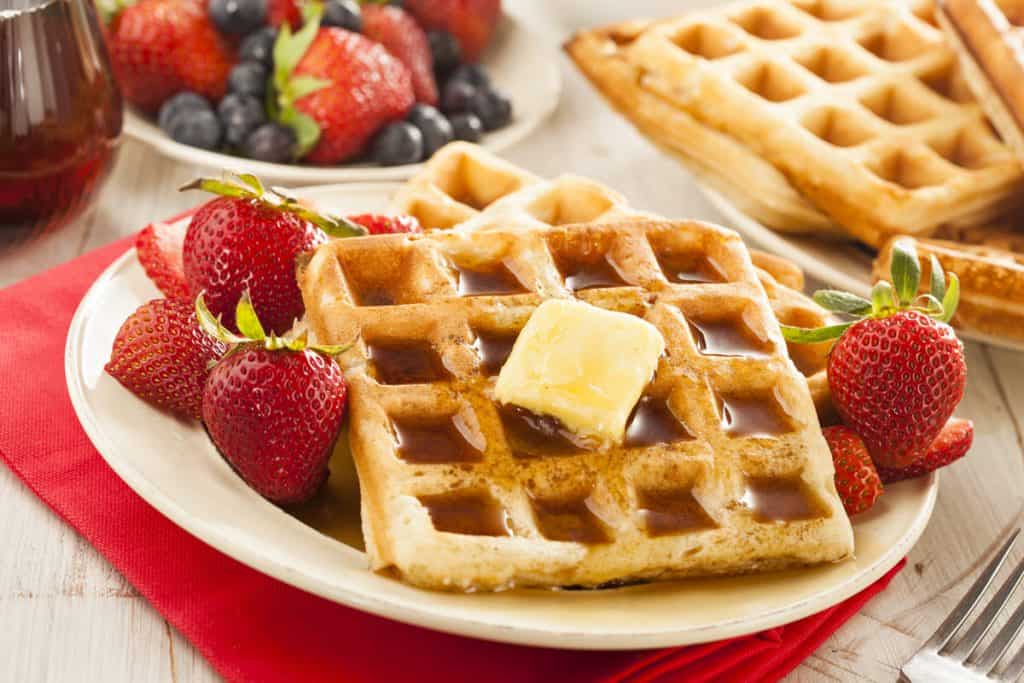 waffles with butter, syrup, and strawberries