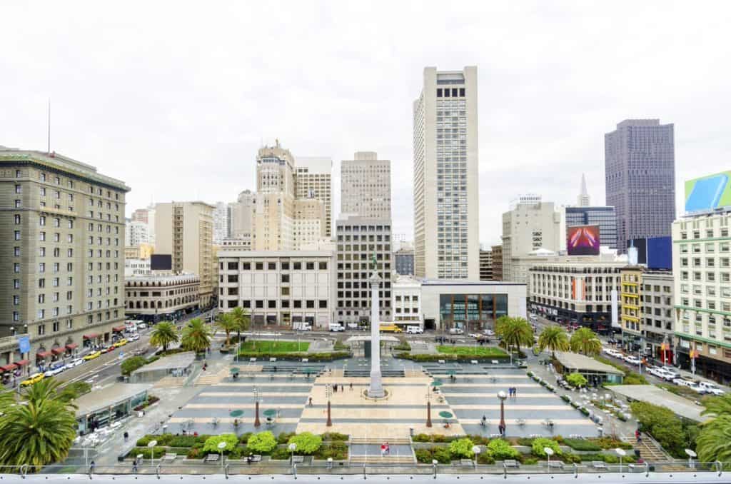 Plaza in the middle of a city under a grey sky