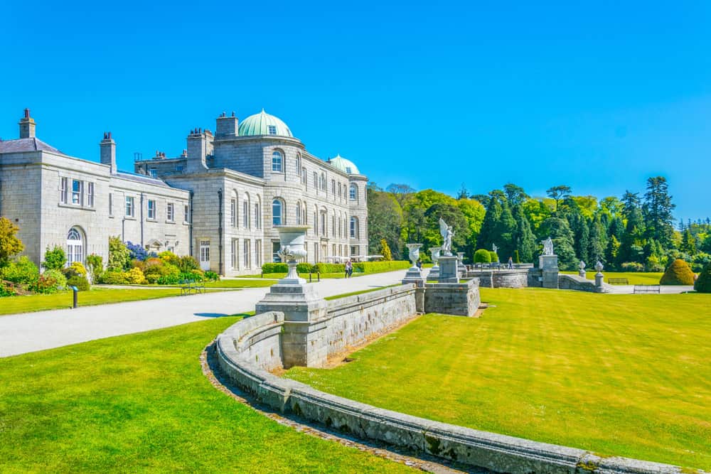 Large estate with a gravel walkway stretched across the front and a large grassy area