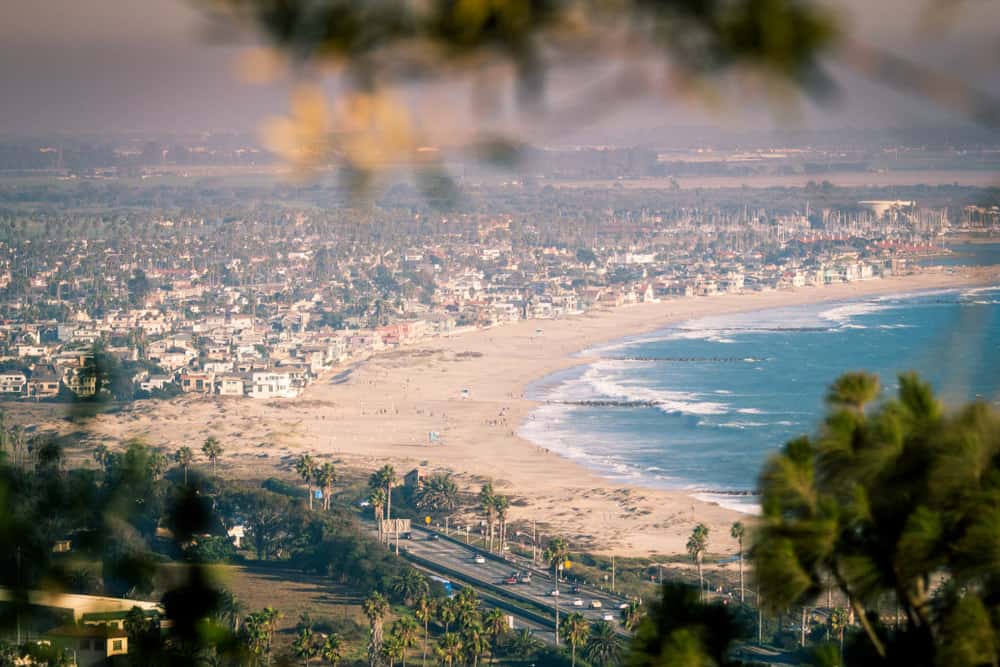 view of a city right on the edge of the ocean from an overlook