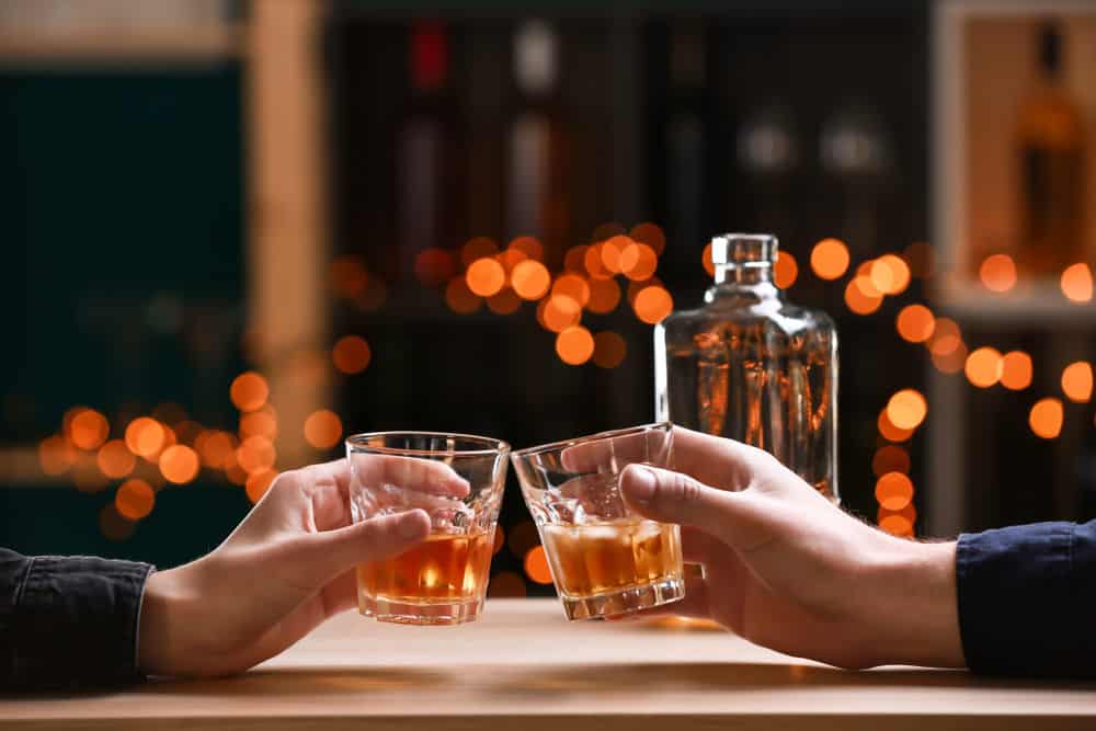 Two people clinking glasses.