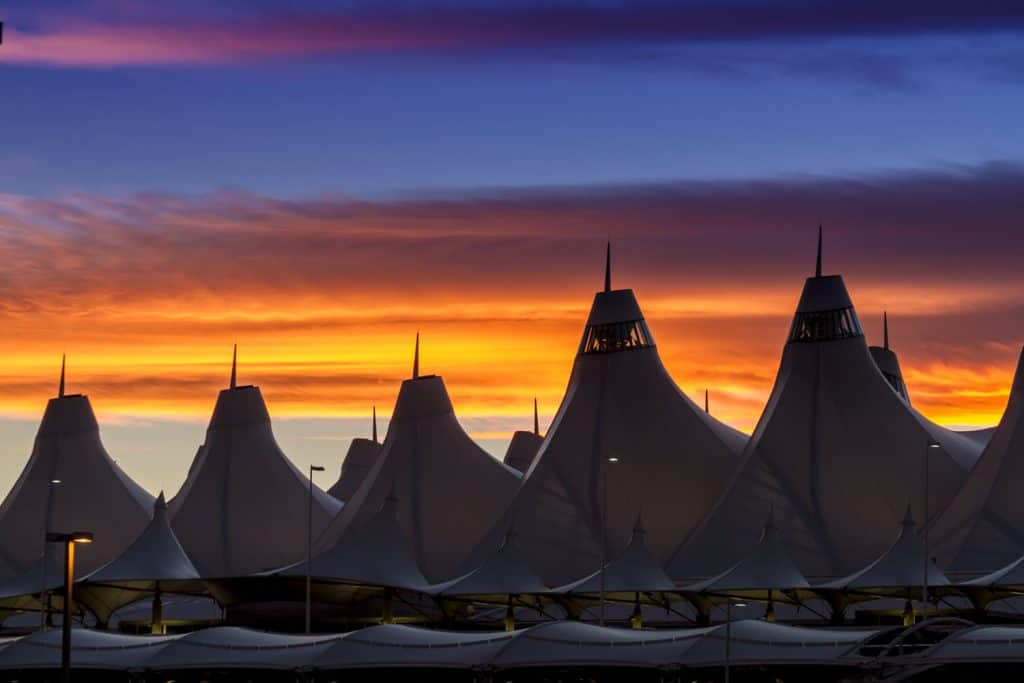 Purple and orange sky over an airport.