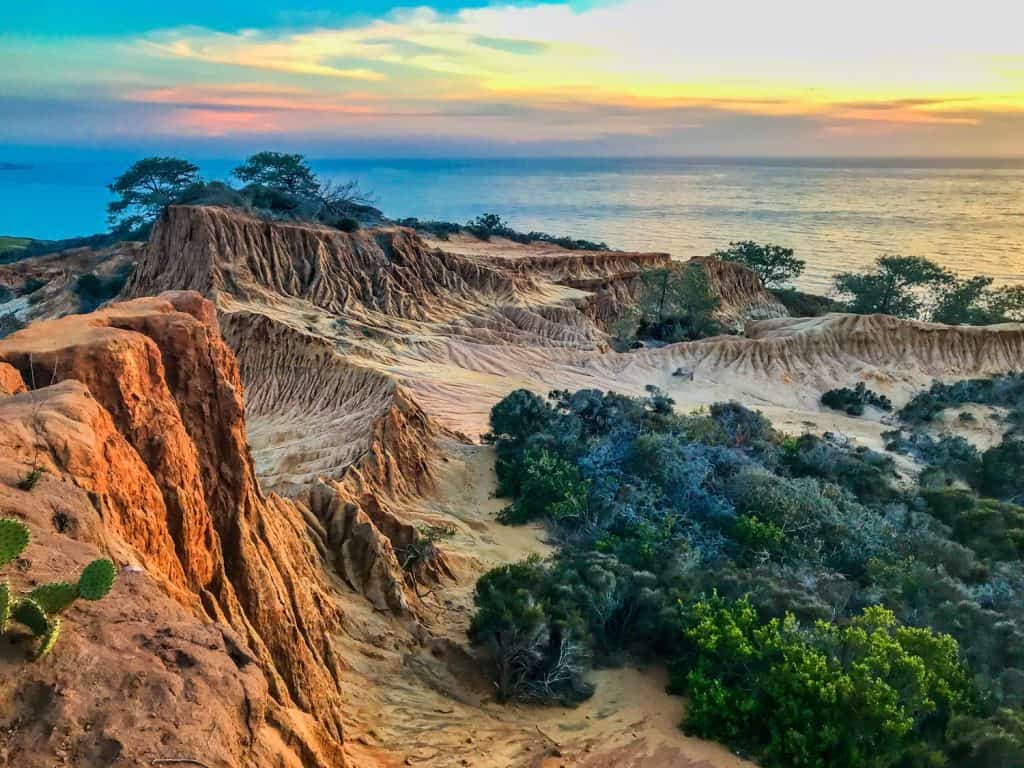 Sunset over a unique desert landscape by the ocean.