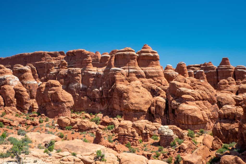 Orange rock formations under a blue sky.