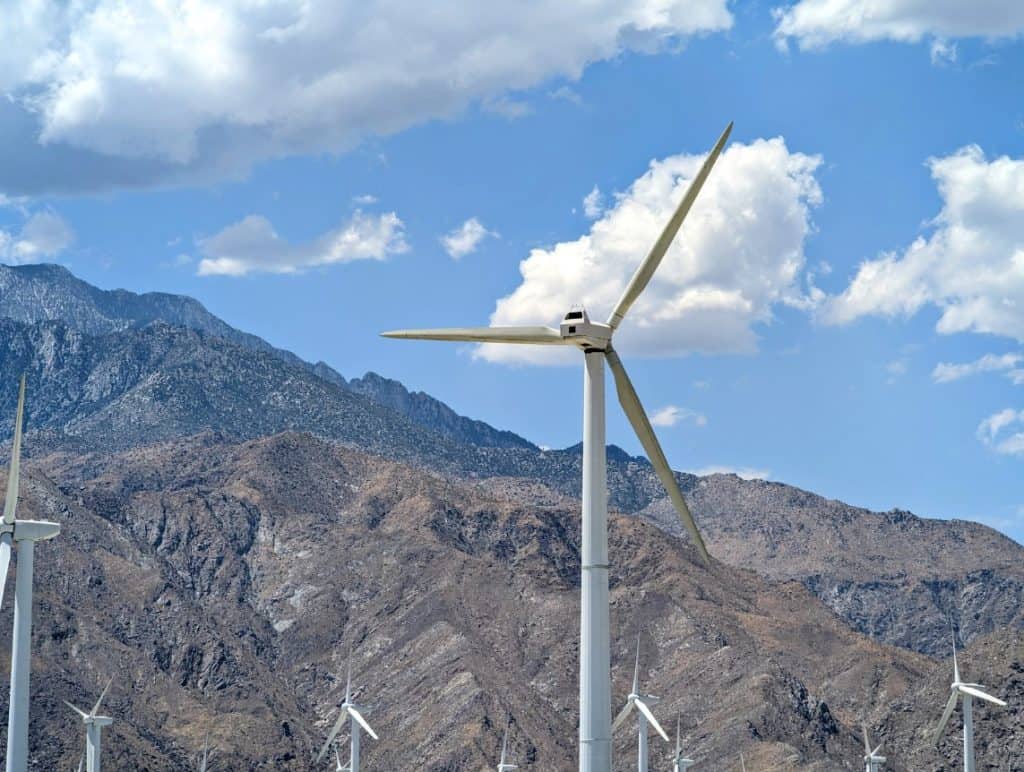 A wind turbine farm with mountains in the distance in Palm Springs.
