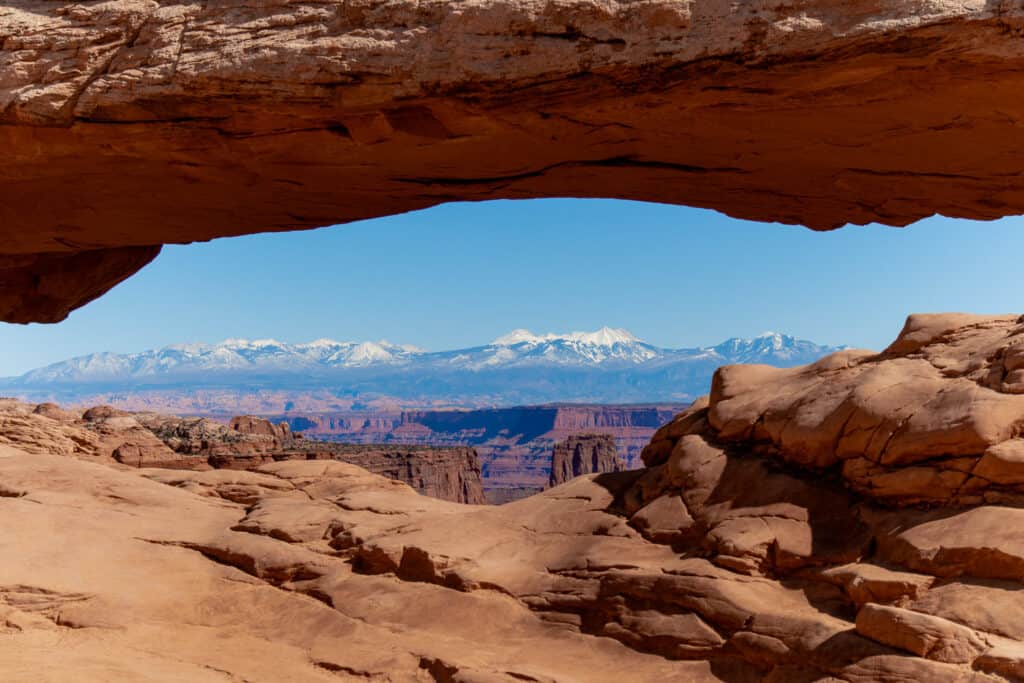Rocky overhang with view through showing mountains in background