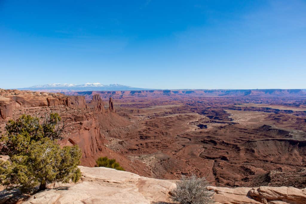 Overhead view of rocky cliffs with mountain range in the background